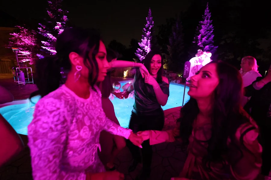 Friends by the pool at night